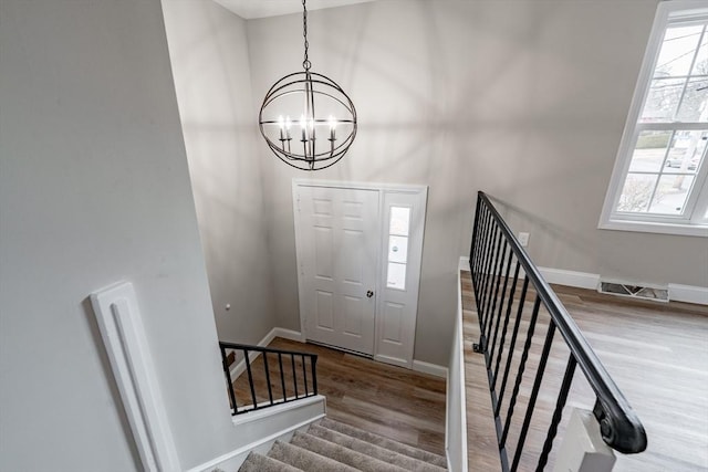 entryway featuring a chandelier and hardwood / wood-style floors