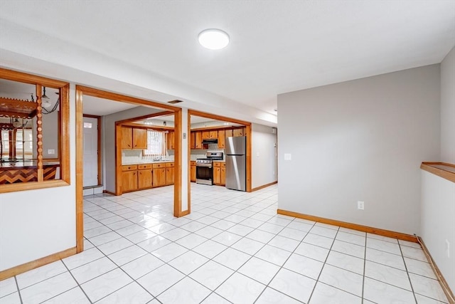 interior space with light tile patterned floors and sink