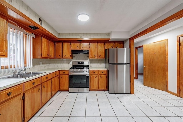 kitchen with exhaust hood, sink, stainless steel appliances, and light tile patterned flooring