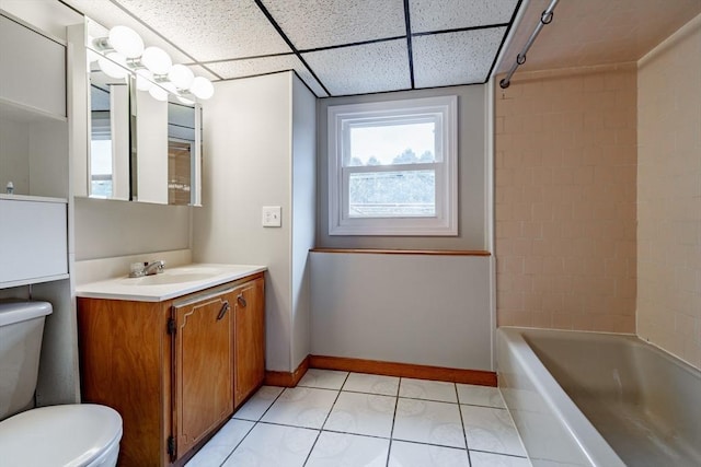 full bathroom featuring toilet, bathtub / shower combination, a paneled ceiling, tile patterned floors, and vanity