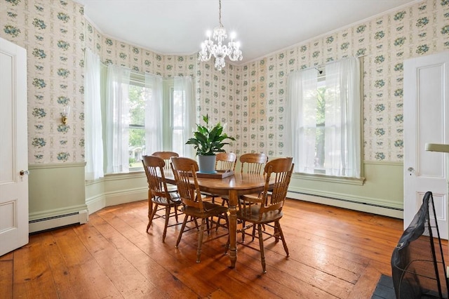127 E St, East Bridgewater, MA 02333 - dining area featuring a baseboard radiator, hardwood / wood-style flooring, a chandelier, crown molding, and wallpapered walls