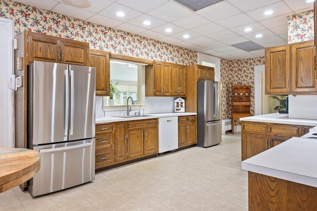 127 E St, East Bridgewater, MA 02333 - kitchen featuring freestanding refrigerator, wallpapered walls, white dishwasher, brown cabinetry, and a drop ceiling