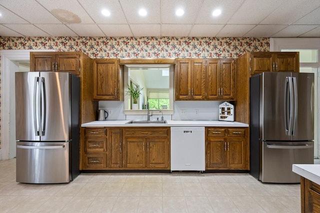 127 E St, East Bridgewater, MA 02333 - kitchen with freestanding refrigerator, white dishwasher, wallpapered walls, a sink, and light countertops