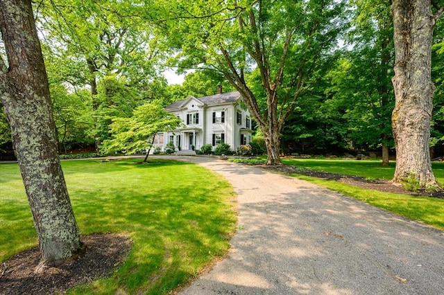 127 E St, East Bridgewater, MA 02333 - colonial inspired home featuring a front lawn and a chimney