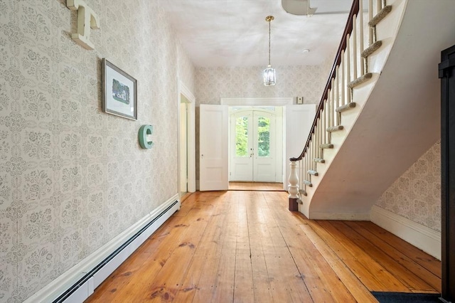 127 E St, East Bridgewater, MA 02333 - entrance foyer featuring a baseboard heating unit, wallpapered walls, hardwood / wood-style floors, stairway, and baseboards