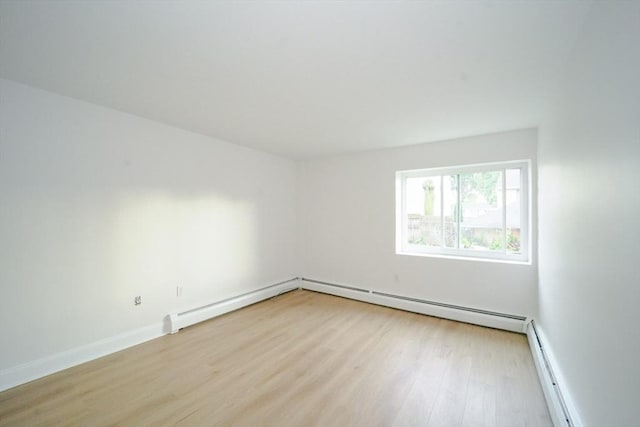 80 Main St Unit 4, Malden, MA 02148 - empty room featuring light wood-type flooring, a baseboard heating unit, and baseboards