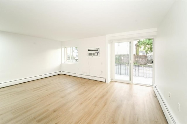 80 Main St Unit 4, Malden, MA 02148 - unfurnished room featuring a baseboard heating unit, light wood finished floors, baseboard heating, and an AC wall unit