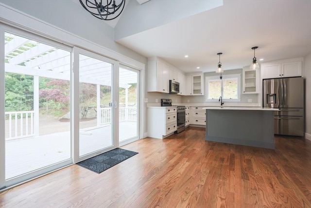 93 Hollis Rd, Plymouth, MA 02360 - kitchen with appliances with stainless steel finishes, glass insert cabinets, white cabinetry, light countertops, and recessed lighting