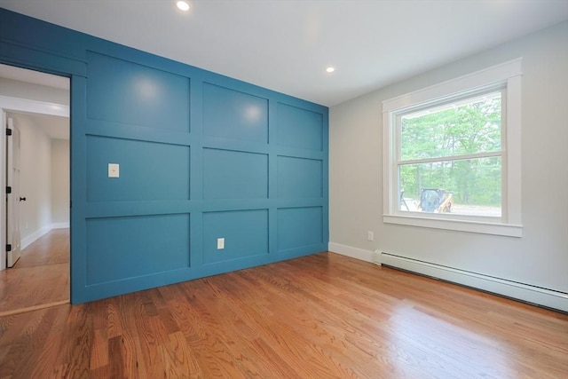 93 Hollis Rd, Plymouth, MA 02360 - unfurnished bedroom featuring a decorative wall, a baseboard heating unit, light wood-type flooring, recessed lighting, and baseboards