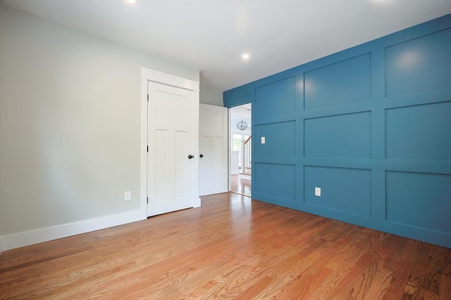 93 Hollis Rd, Plymouth, MA 02360 - unfurnished bedroom featuring light wood finished floors, a decorative wall, recessed lighting, and baseboards