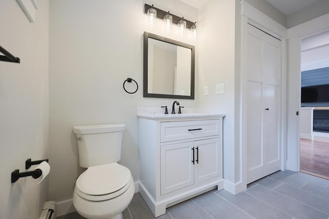 93 Hollis Rd, Plymouth, MA 02360 - bathroom with tile patterned flooring, toilet, a baseboard heating unit, vanity, and baseboards