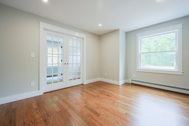 93 Hollis Rd, Plymouth, MA 02360 - empty room with wood finished floors, a baseboard radiator, baseboards, recessed lighting, and french doors