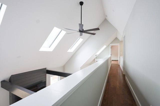 93 Hollis Rd, Plymouth, MA 02360 - hallway with a skylight, dark wood-type flooring, an upstairs landing, baseboards, and high vaulted ceiling