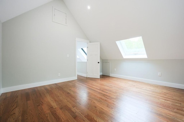 93 Hollis Rd, Plymouth, MA 02360 - additional living space with a skylight, vaulted ceiling, wood finished floors, and baseboards