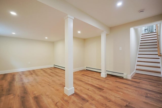93 Hollis Rd, Plymouth, MA 02360 - finished basement featuring a baseboard heating unit, light wood finished floors, recessed lighting, stairway, and baseboards