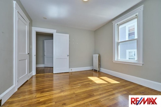 150 Nonantum St, Boston, MA 02135 - spare room with radiator heating unit, baseboards, and wood finished floors