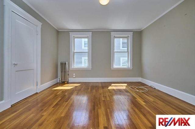 150 Nonantum St, Boston, MA 02135 - empty room with radiator, hardwood / wood-style floors, baseboards, and crown molding