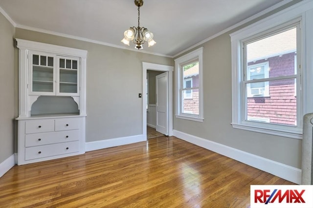 150 Nonantum St, Boston, MA 02135 - unfurnished dining area featuring a chandelier, light wood-type flooring, baseboards, and crown molding