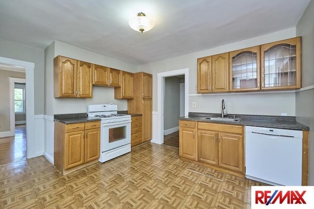 150 Nonantum St, Boston, MA 02135 - kitchen featuring white appliances, a sink, dark countertops, brown cabinets, and glass insert cabinets