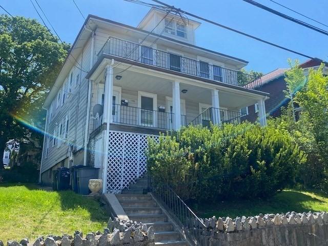 150 Nonantum St, Boston, MA 02135 - american foursquare style home with a balcony, stairway, a front yard, and a porch