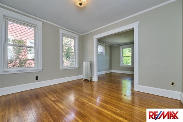 150 Nonantum St, Boston, MA 02135 - empty room featuring radiator heating unit, hardwood / wood-style flooring, ornamental molding, and baseboards