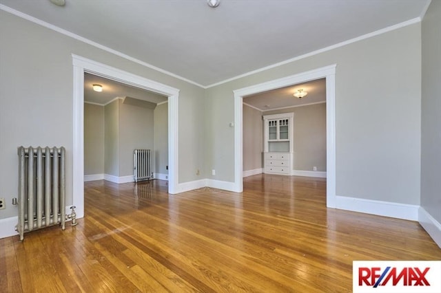 150 Nonantum St, Boston, MA 02135 - spare room with radiator heating unit, wood finished floors, crown molding, and baseboards