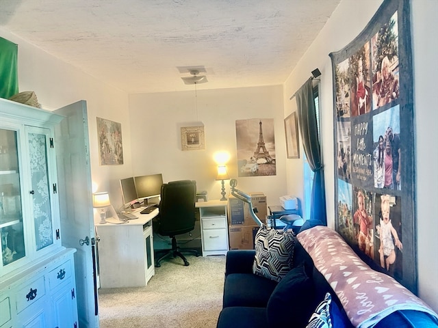 carpeted home office with a textured ceiling