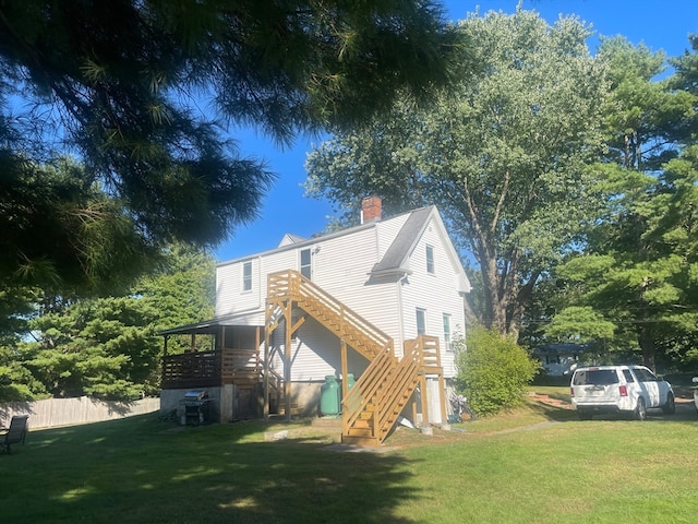 back of property featuring a yard