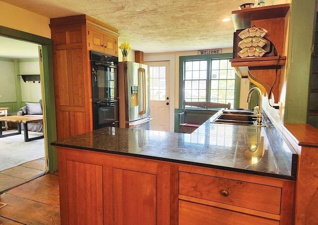 164 Worcester Rd, Westminster, MA 01473 - kitchen with a sink, stainless steel refrigerator with ice dispenser, a peninsula, brown cabinets, and a textured ceiling