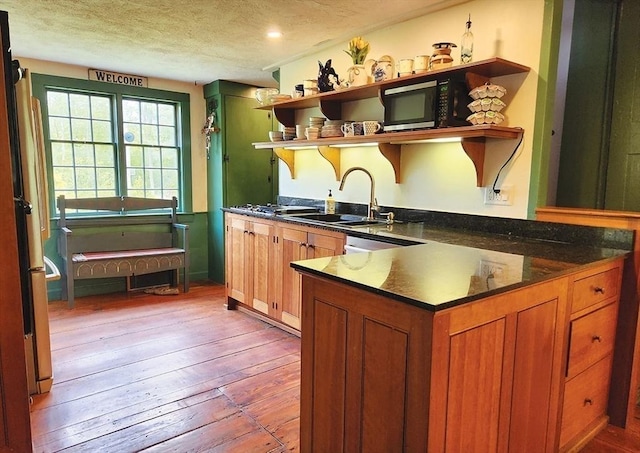 164 Worcester Rd, Westminster, MA 01473 - kitchen featuring open shelves, a sink, wood-type flooring, a textured ceiling, and brown cabinets