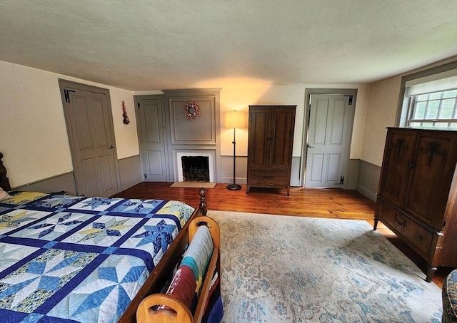 164 Worcester Rd, Westminster, MA 01473 - bedroom with wood finished floors and a fireplace with flush hearth