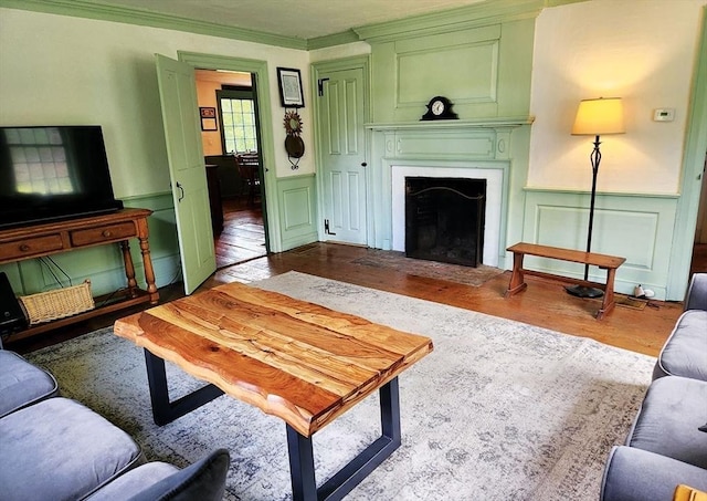 164 Worcester Rd, Westminster, MA 01473 - living room with a decorative wall, wood finished floors, a fireplace with flush hearth, wainscoting, and ornamental molding