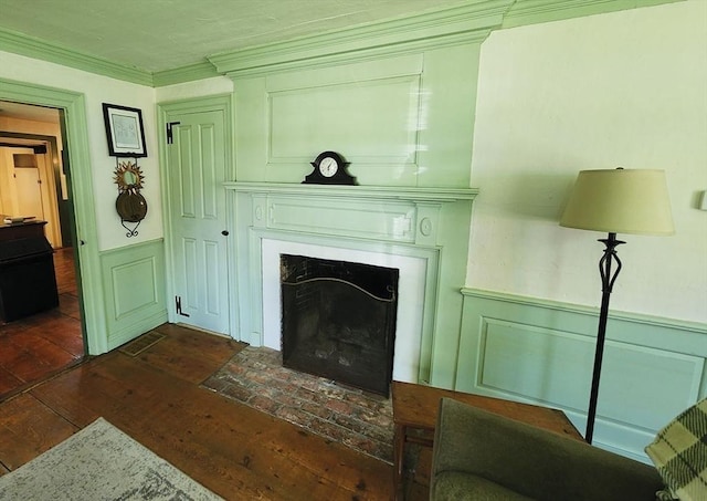 164 Worcester Rd, Westminster, MA 01473 - living area with dark wood-style floors, a fireplace with flush hearth, a wainscoted wall, ornamental molding, and a decorative wall
