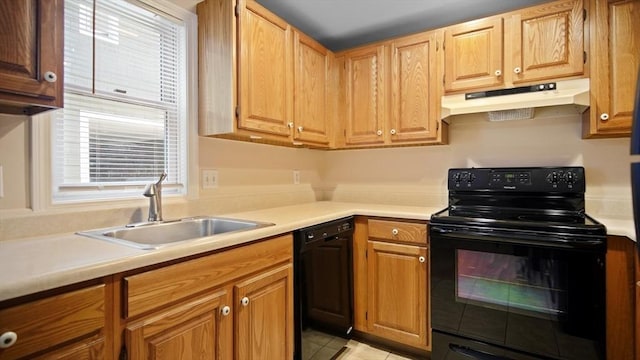 kitchen featuring under cabinet range hood, black appliances, a sink, light countertops, and light tile patterned floors