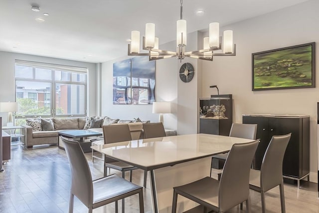 dining area featuring a chandelier and light wood-type flooring