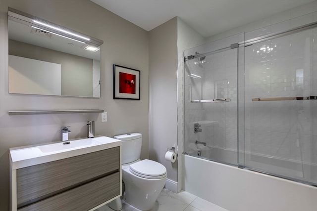 full bathroom featuring vanity, toilet, and bath / shower combo with glass door