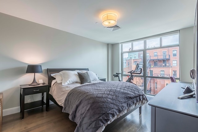 bedroom with dark wood-type flooring