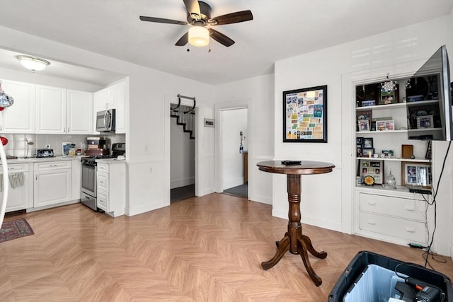 381 Hunnewell St Unit 381, Needham, MA 02494 - kitchen with gas range oven, stainless steel microwave, a ceiling fan, light countertops, and white cabinets