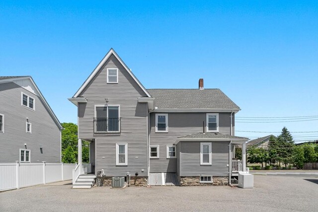 381 Hunnewell St Unit 381, Needham, MA 02494 - rear view of property featuring a chimney, central air condition unit, and a shingled roof