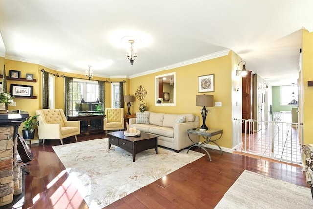 living area featuring baseboards, an inviting chandelier, dark wood finished floors, and crown molding