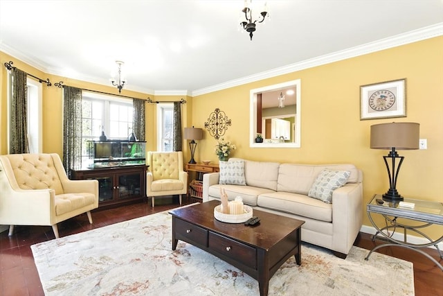 living area with wood finished floors, baseboards, and ornamental molding