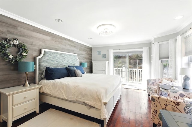 bedroom featuring dark wood finished floors, ornamental molding, an accent wall, and access to outside