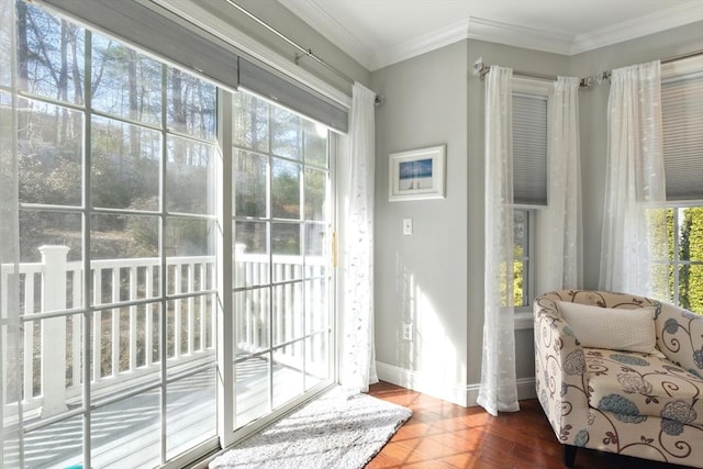 doorway to outside with crown molding, baseboards, and wood finished floors