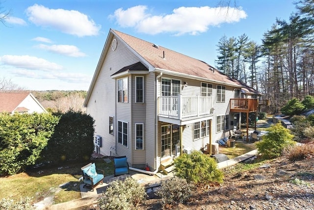 back of house featuring a wooden deck, a patio, and entry steps