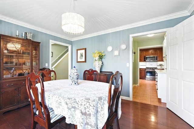 dining room featuring an inviting chandelier, wood finished floors, and ornamental molding