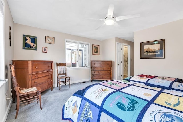 carpeted bedroom with visible vents, baseboards, and ceiling fan