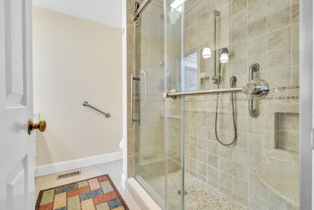 full bath featuring visible vents, baseboards, a shower stall, and tile patterned flooring