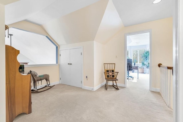 sitting room featuring lofted ceiling, carpet flooring, and baseboards