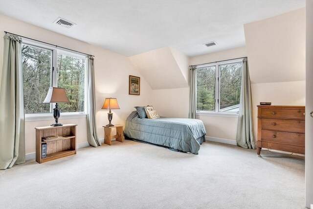 carpeted bedroom featuring visible vents, baseboards, and lofted ceiling