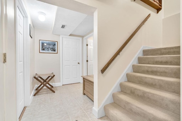 stairs featuring visible vents and baseboards